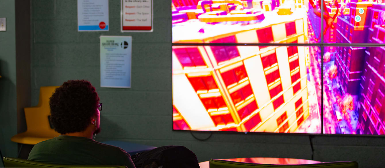 A teen plays a Spiderman game in the Teen Zone