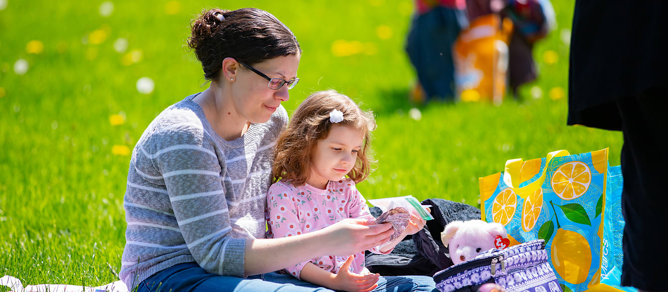 A mother and daughter examine the surprise snack offered to them in a ziploc bag.