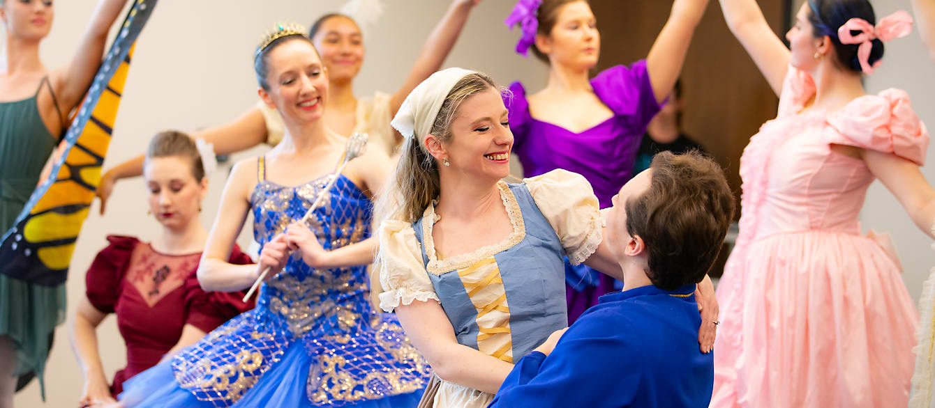 A group of ballet performers in costume surround the performers dressed as Cinderella and Prince Charming as they dance