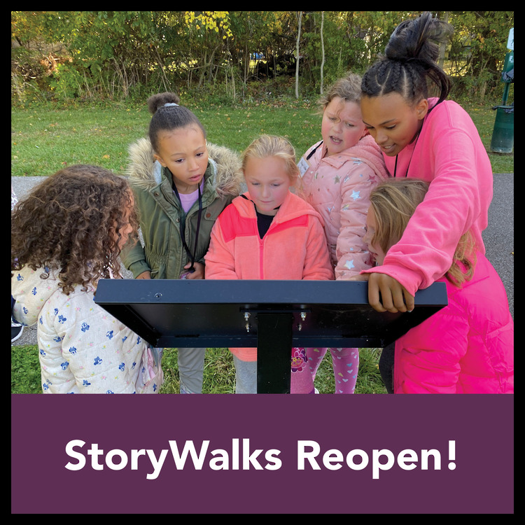 Children reading the story book on the trail